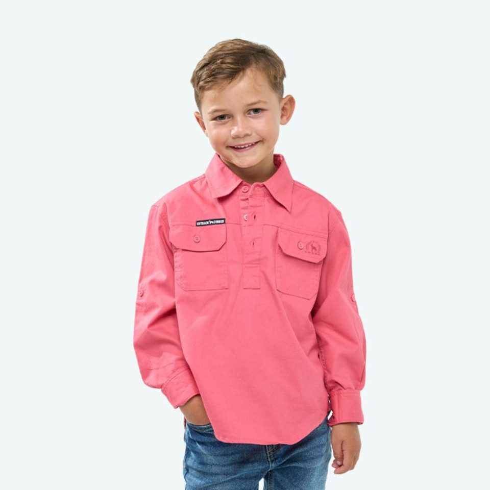 Front view of the Outback Cobber Hazeldean Kids Half Button Long Sleeve Work Shirt in pink, showcasing long sleeves, dual button-flap chest pockets, and a classic workwear design.