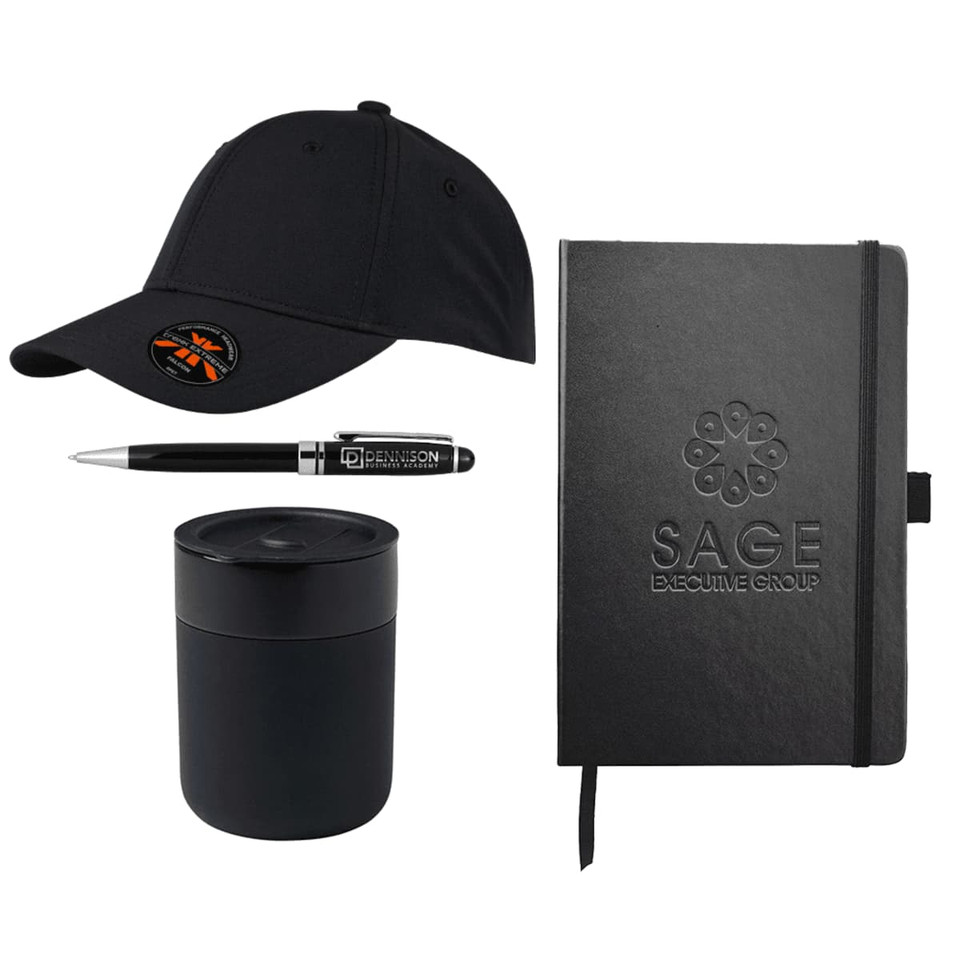 A black cap, black pen, black candle, and black notebook, all featuring branding elements.