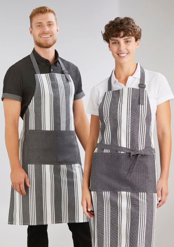 A striped grey and white apron is worn by a smiling man and woman. The aprons have a logo on them.