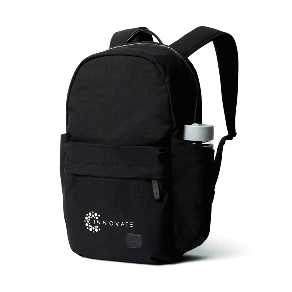 A black backpack with a front pocket and a drink bottle holder, featuring a logo on the side.
