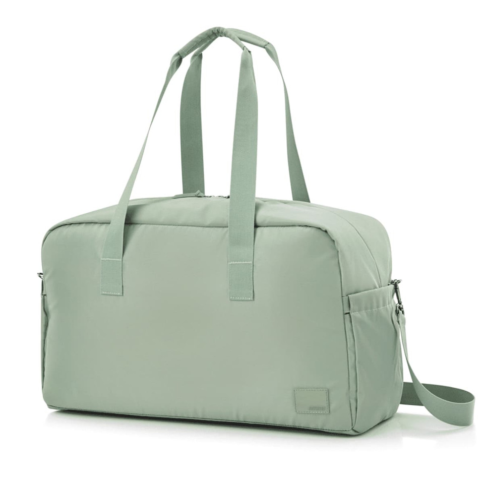 A light green duffle bag with two handles, a shoulder strap, and a simple design, featuring a logo.