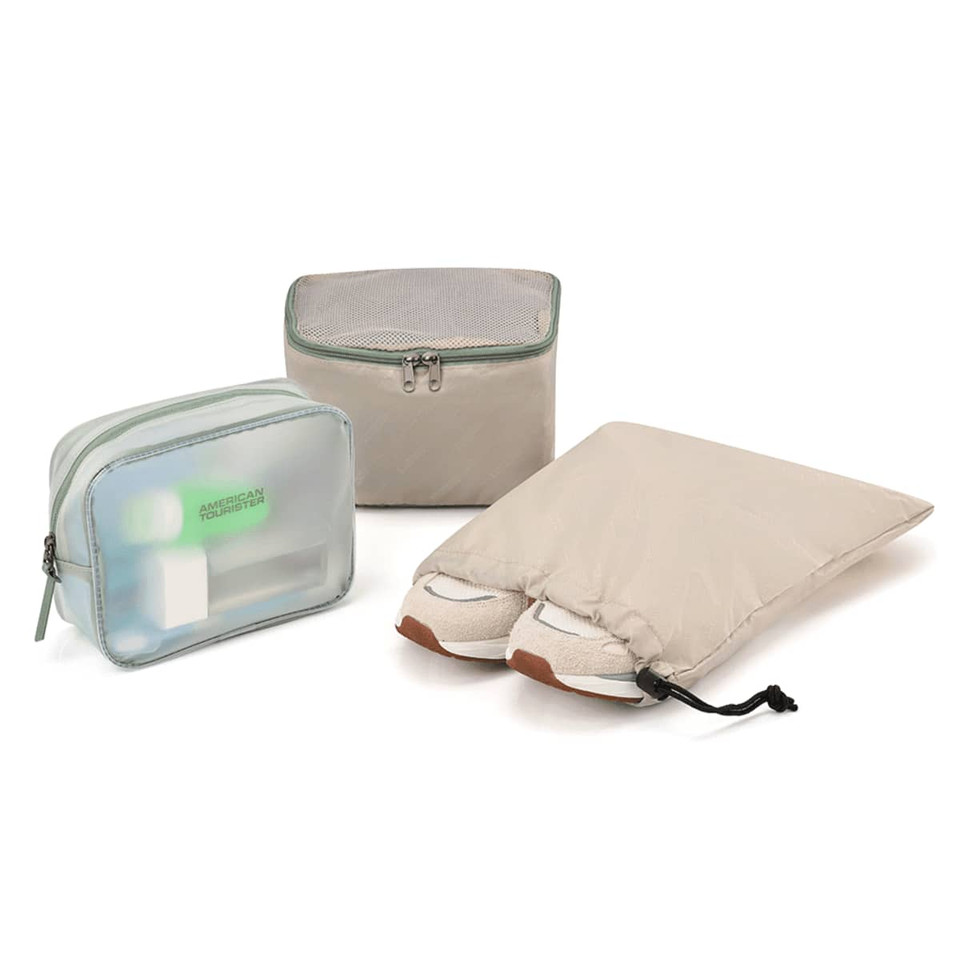 A beige duffle bag set including a transparent pouch, a zipped container, and a shoe bag with shoes.