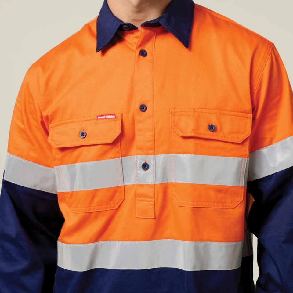 Man wearing an orange and navy taped high-visibility work shirt.