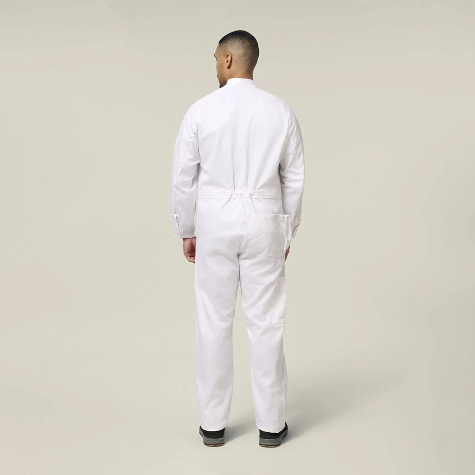 Back view of a male model wearing a white work jumpsuit and black work boots against a neutral background.