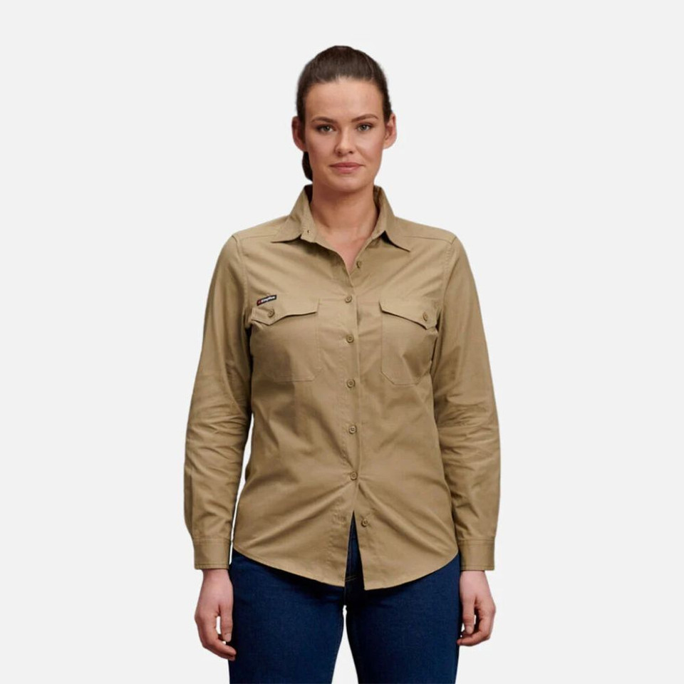 Woman wearing khaki long-sleeve utility shirt and blue jeans.