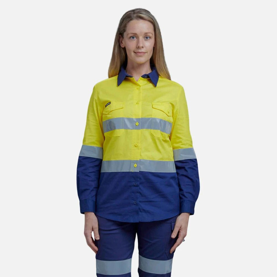 A woman wearing a yellow and navy hi-vis long sleeve shirt with refelective tape