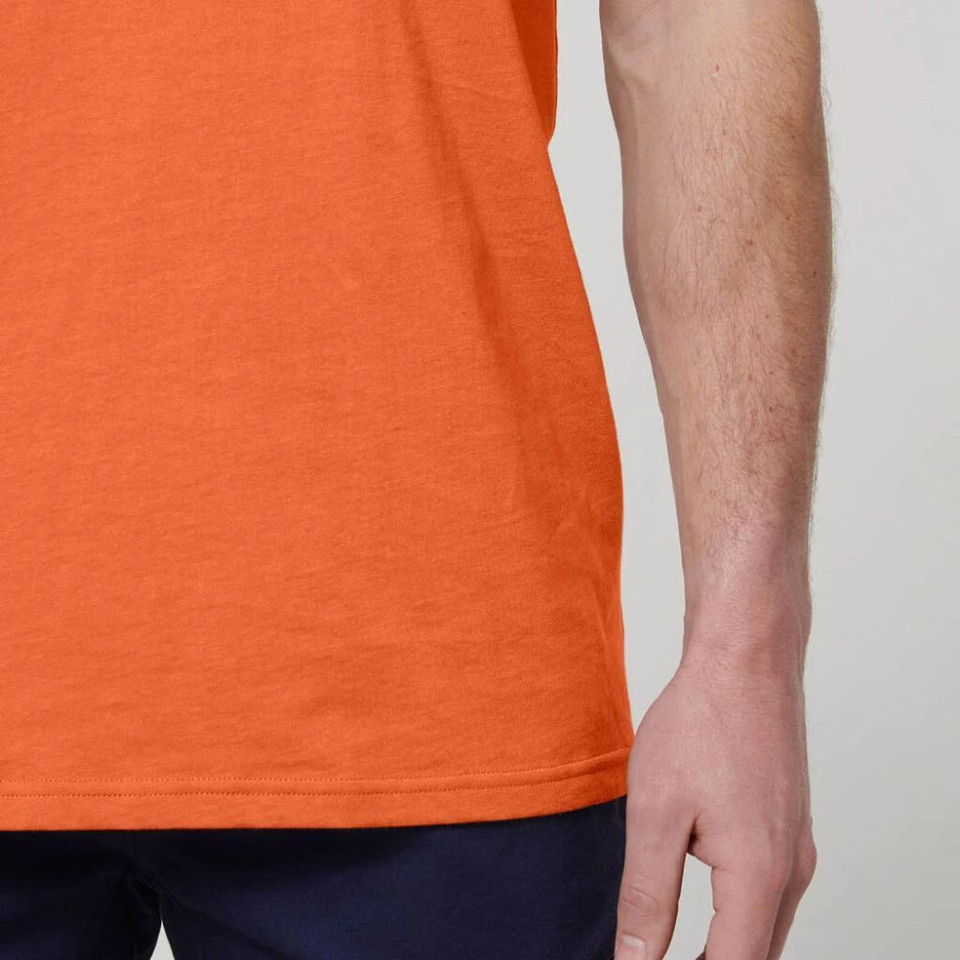 Orange t-shirt and navy pants detail on model.