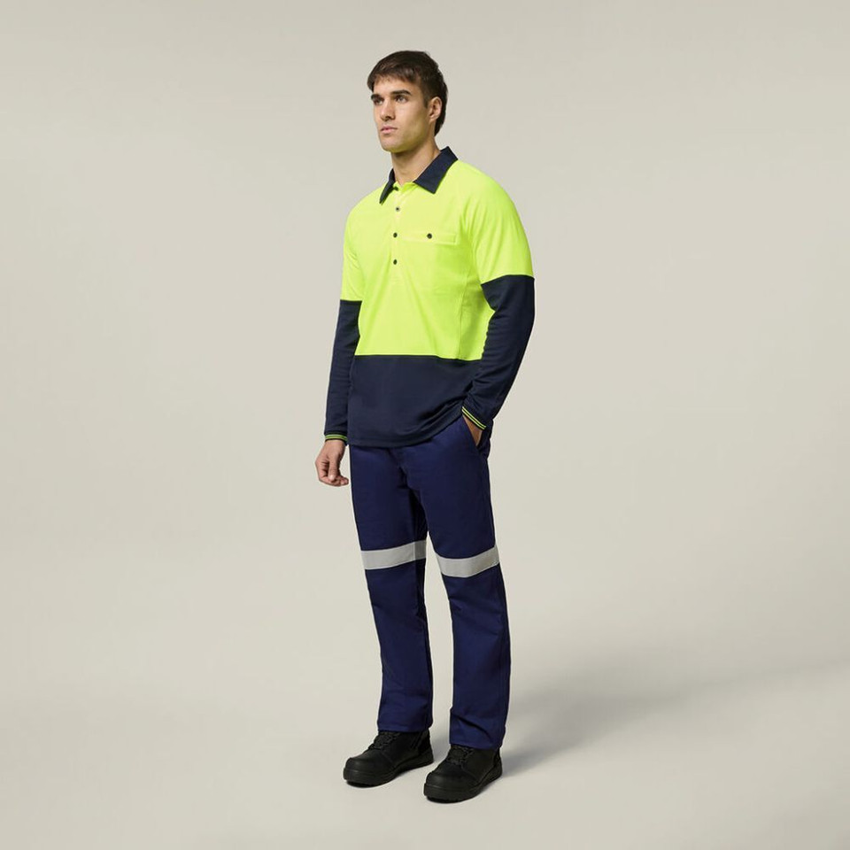 Man wearing high-visibility workwear with safety reflective pants and bright yellow top.