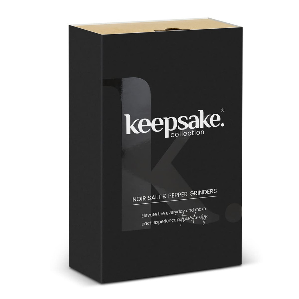 A black box containing Keepsake Noir salt and pepper grinders, featuring a sleek logo and elegant design.