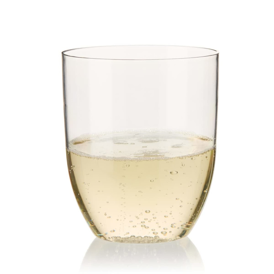 A stemless shatterproof wine glass made from clear Recycled Tritan™, filled with sparkling white wine.
