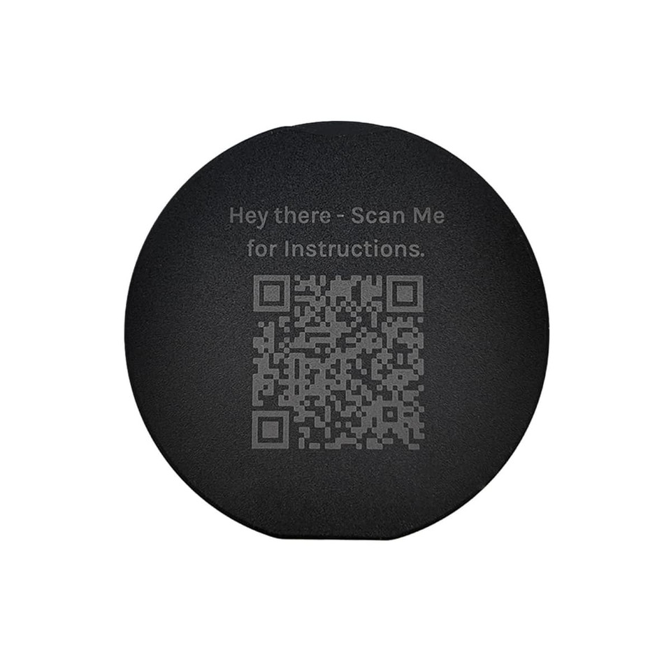 A circular black phone grip featuring a QR code and text for instructions.