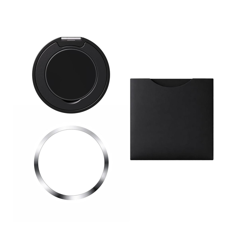 A black circular phone grip and stand with a silver ring, enclosed in a matching black holder.