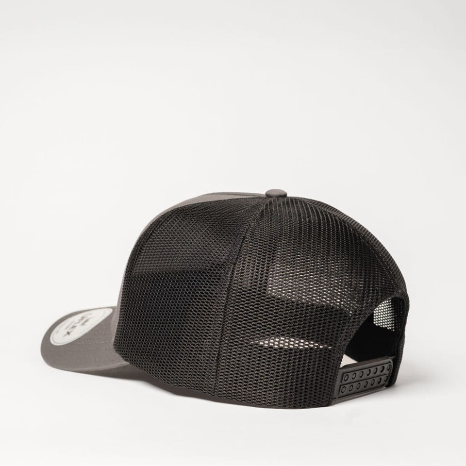 A UFlex Classic Ultra-lite 5 Panel Trucker Cap in black with a mesh back and a branded logo on the side.
