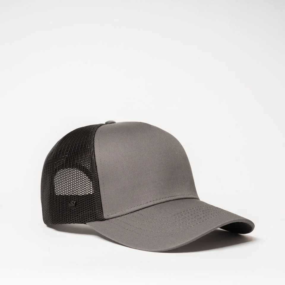 A grey trucker cap with a black mesh back and a logo on the side.