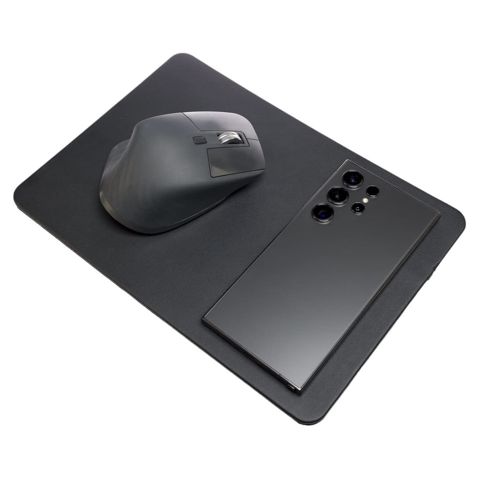 A sleek black mouse pad with an integrated wireless charger, featuring a smartphone and a computer mouse on top.