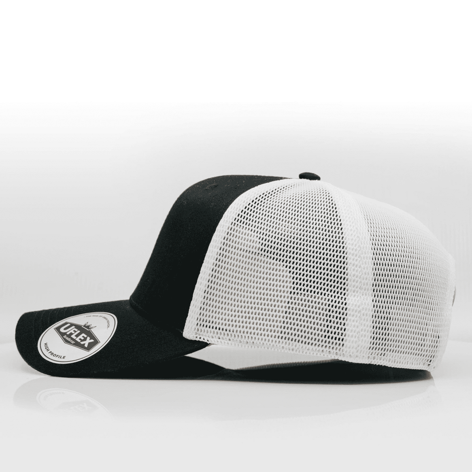 A black and white trucker cap with a mesh back and a round logo patch on the front.