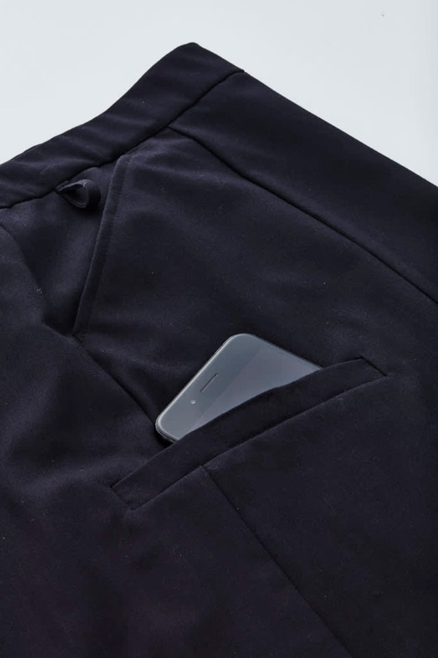 A black cargo skirt with a smartphone tucked into a side pocket. The fabric appears soft and comfortable.