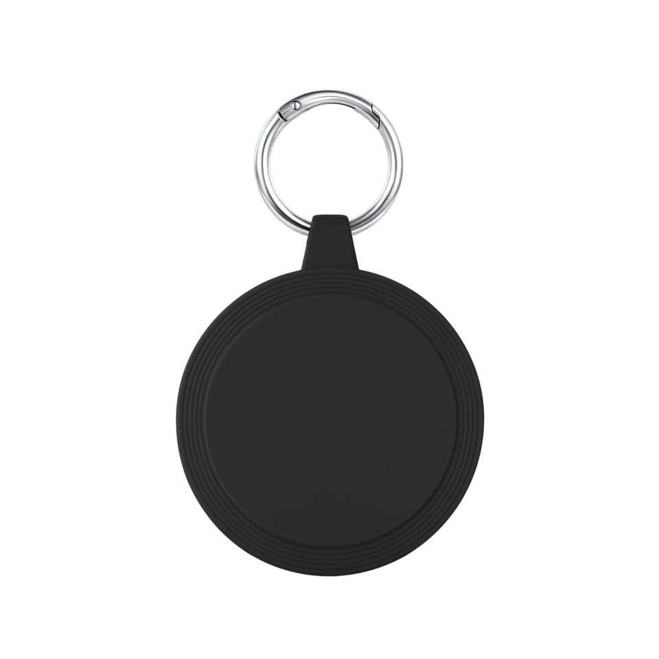 A round black keychain holder features a silver keyring. The surface is smooth with subtle grooves around the edge.