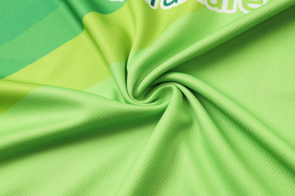 A vibrant green micro mesh fabric featuring a subtle pattern, perfect for a long-sleeved polo shirt, with a logo present.