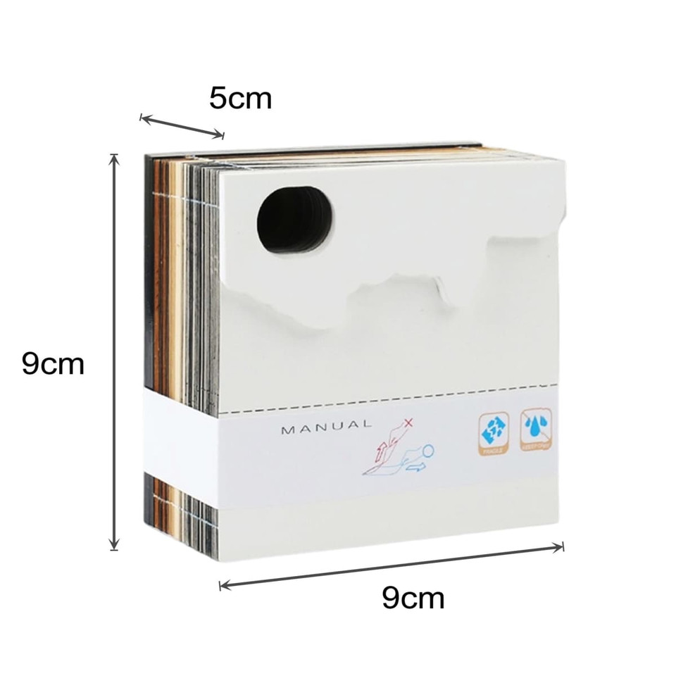 A 3D paper carving notepad in white, measuring 9cm x 9cm x 5cm, with a logo and a manual.