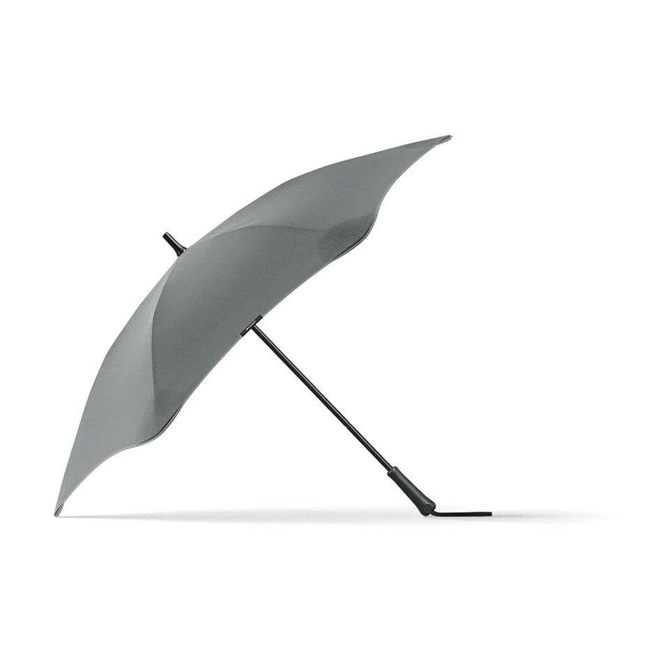 A grey BLUNT Classic Umbrella with a unique, aerodynamic shape and a curved canopy, featuring a logo on the handle.