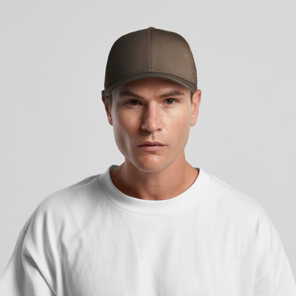A brown mesh trucker cap with a solid front panel, modelled by a person wearing a white T-shirt.