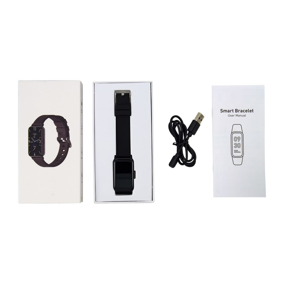 A slim black smart watch in a box, alongside a user manual and a USB charging cable.