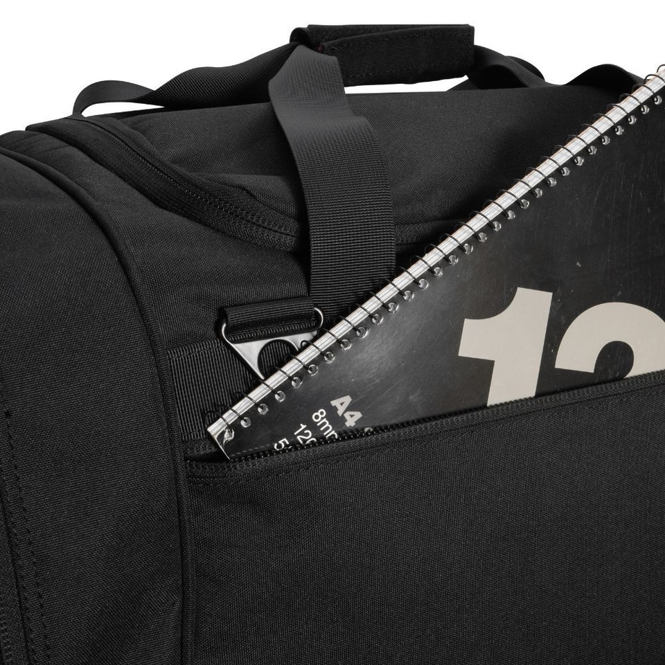 Black duffle bag with A4 spiral notebook in pocket.