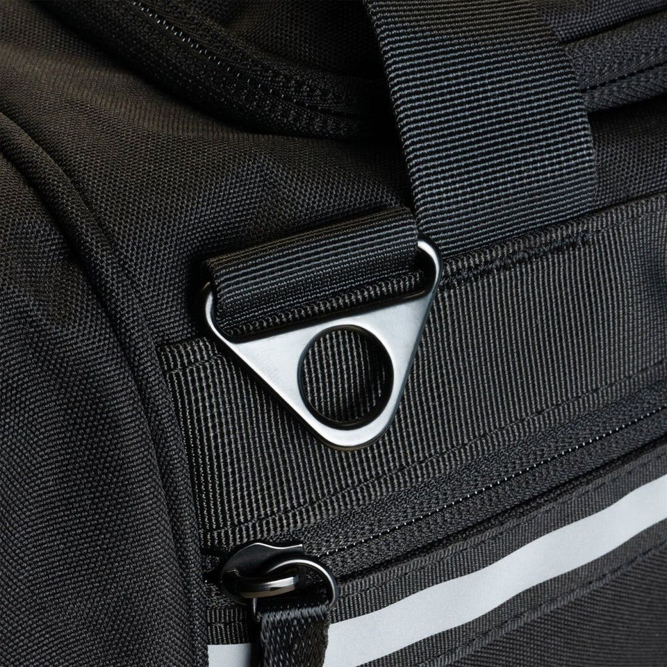 Close-up of a black duffel bag showcasing durable stitching and metal hardware.