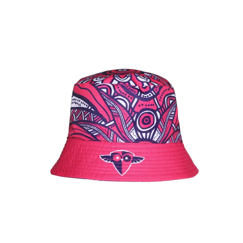 A reversible bucket hat featuring a vibrant pink and navy pattern, with a logo on the front.