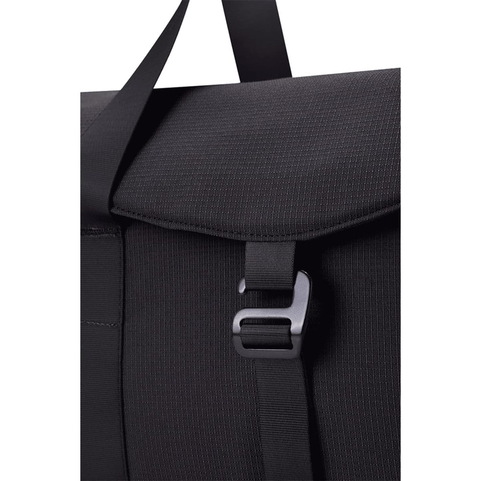 A black duffel bag with a textured finish and a clasp closure, featuring a strap for carrying.