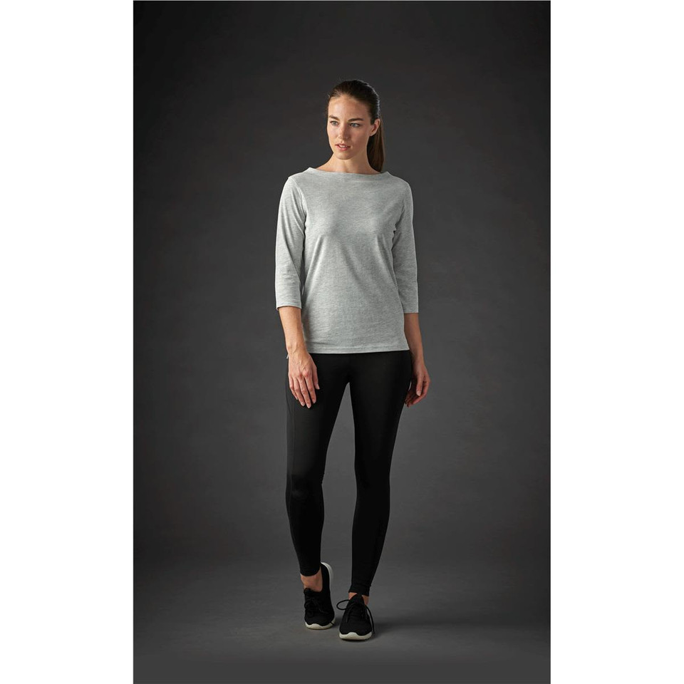 A grey women's 3/4 sleeve tee paired with black leggings, featuring a subtle logo.