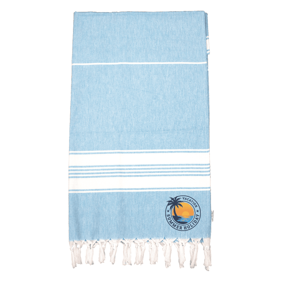 A light blue Turkish towel with white stripes and a circular logo featuring a palm tree and sun.