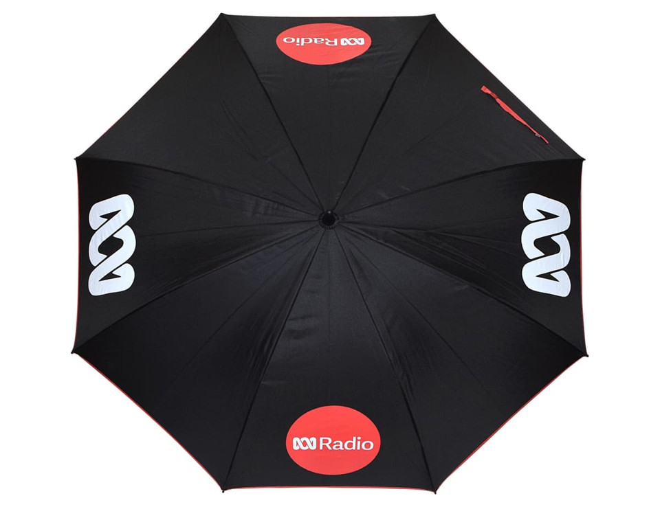 A black umbrella with a design featuring logos, shown from an overhead view.