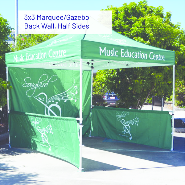 Green music education marquee gazebo with back wall and half sides in a sunny outdoor setting.