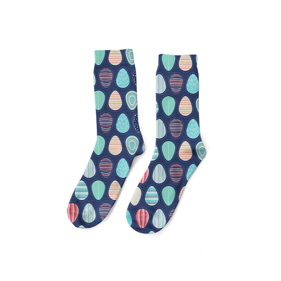 A pair of navy soccer socks featuring colourful, patterned circles in teal, peach, and pink. Includes a logo.