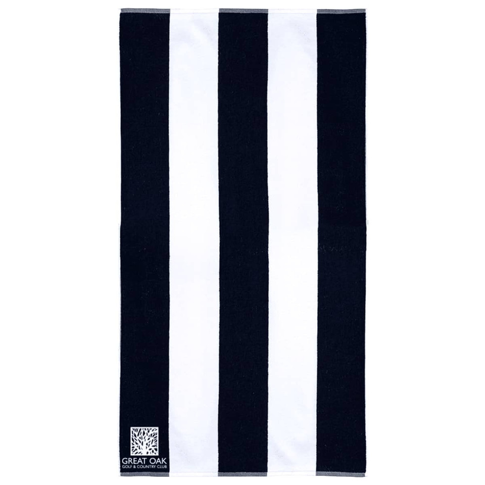 A cotton beach towel featuring a striped pattern in black and white, with a logo in the corner.