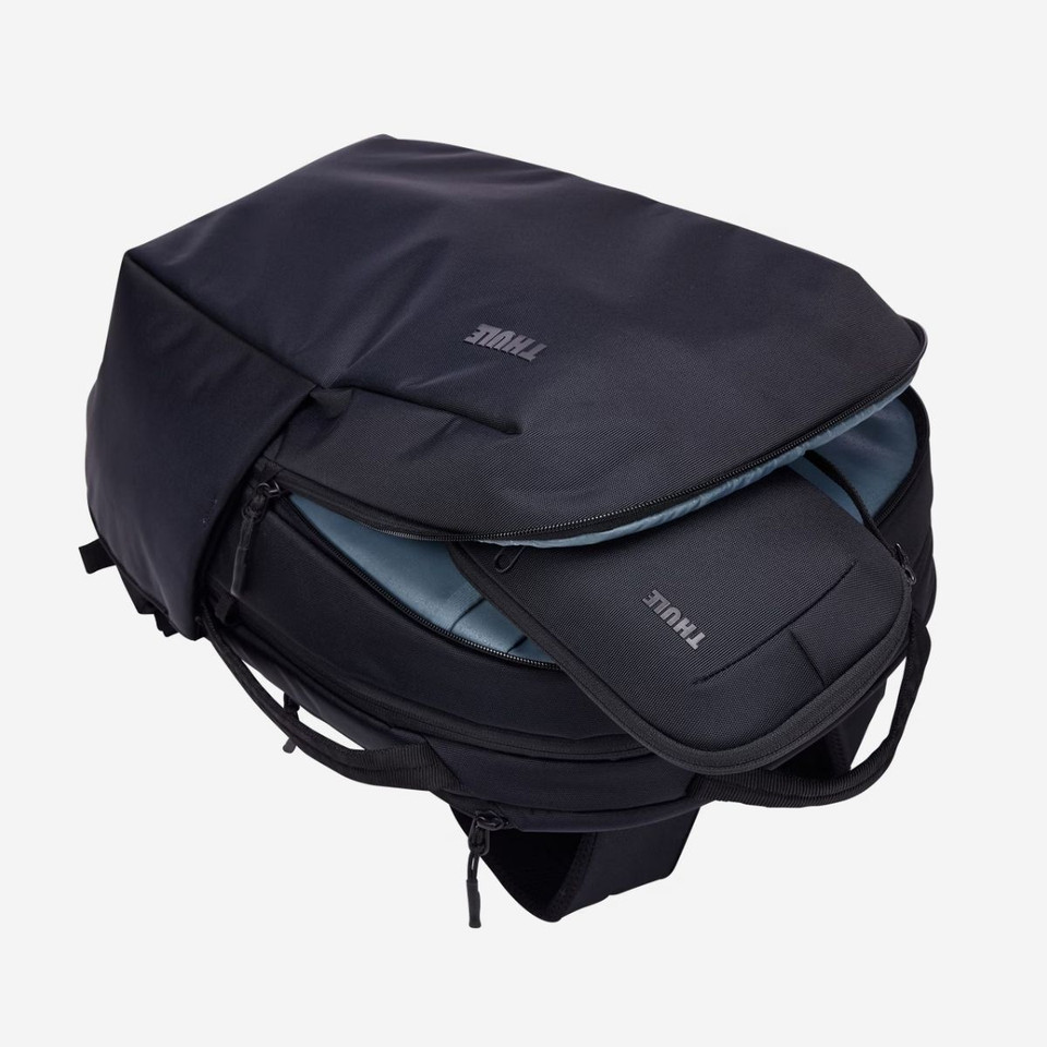 Black Thule backpack with open compartments showing spacious interior and the Thule Subterra 2 Powershuttle organiser fitting perfectly into the backpack.