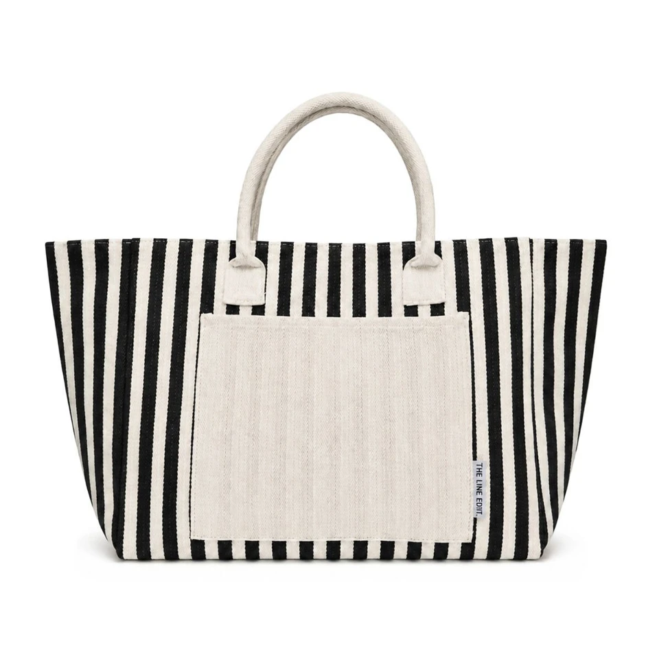 Front view of a black and white striped Hampton tote bag with rounded handles, a spacious front pocket, and a wide open-top silhouette.