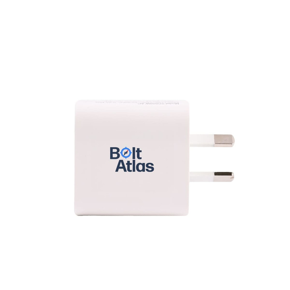A white power adapter with two metal prongs and a logo on one side.
