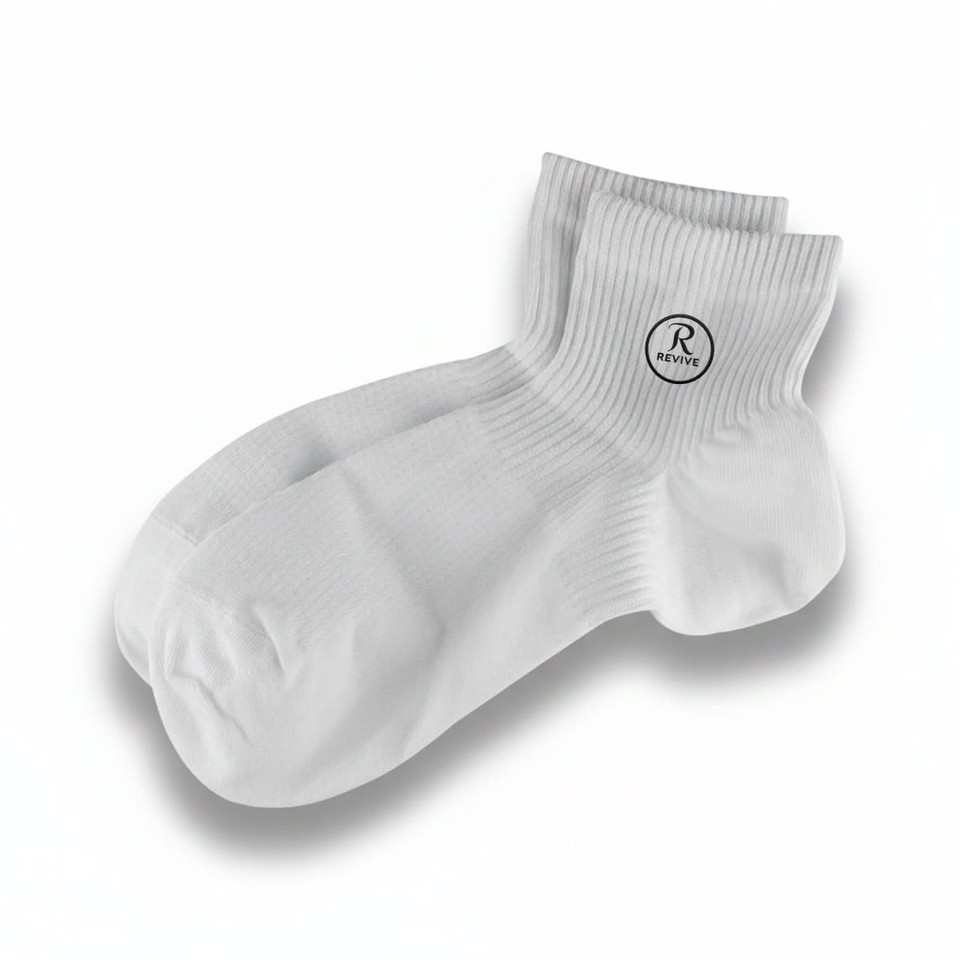 A pair of white socks with a branded logo on one side, featuring a ribbed design.