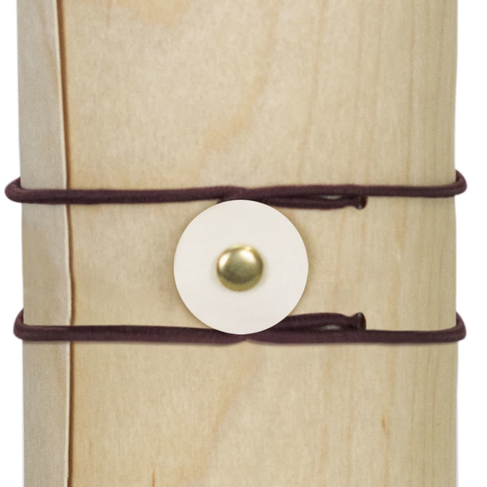 A drink bottle with a natural wood appearance, secured by dark brown straps and a circular fastening.