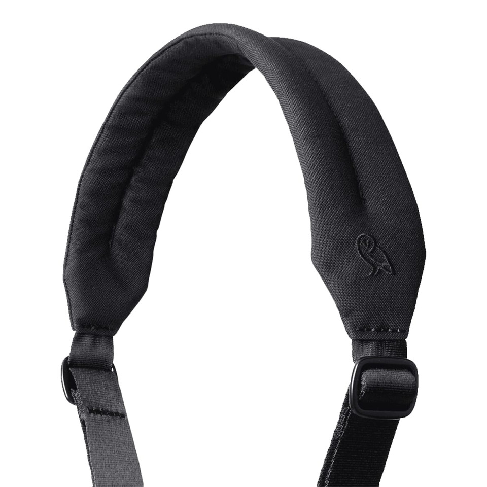 A padded black shoulder strap with an adjustable buckle and a logo at the top.
