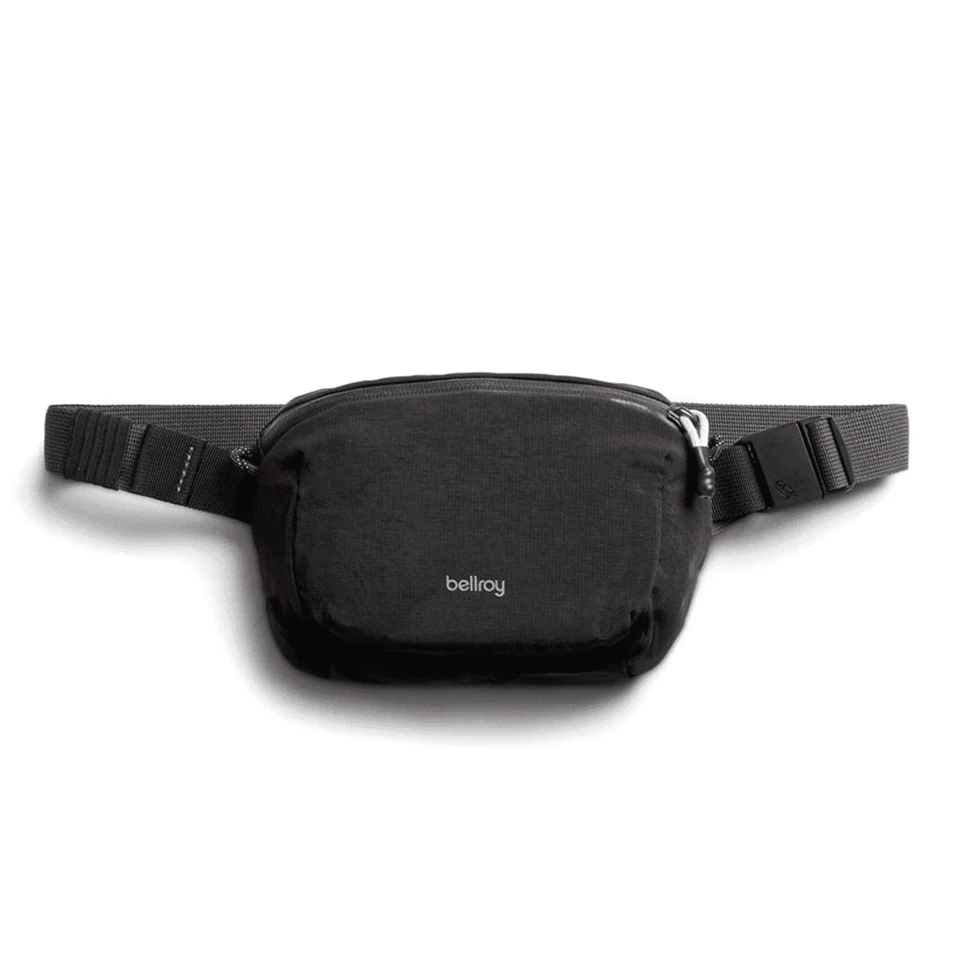 A black bum bag with a sleek design, featuring a logo and an adjustable strap.