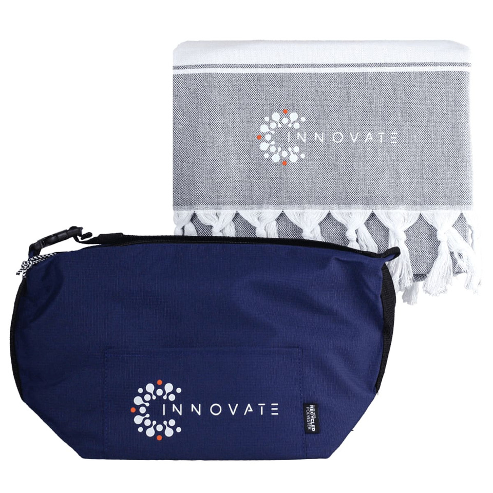 A navy cooler bag and a grey towel with tassels, both featuring a logo.