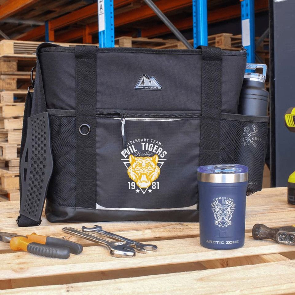 A black cooler bag with mesh pockets, featuring a logo and accompanied by tools and a drink container.