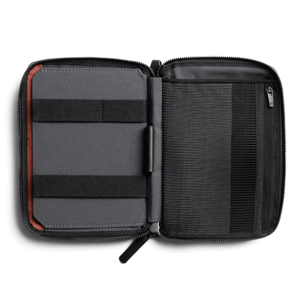 A grey toiletry bag, featuring elastic straps and a zip closure, with an interior compartment for organisation.