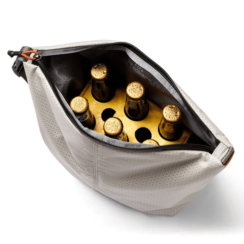 A grey cooler bag with a zipper, containing several drink bottles with golden caps inside.