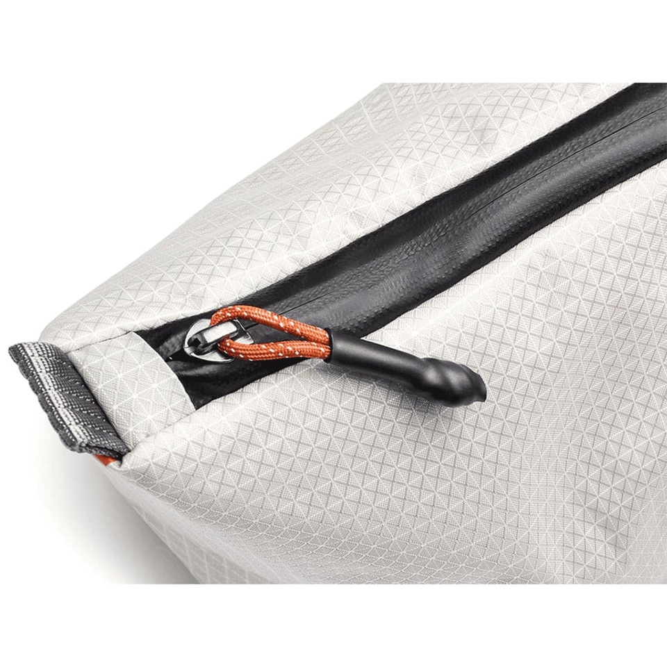 A grey cooler bag with a textured surface and a black zipper, featuring an orange pull tab. It has a logo on it.
