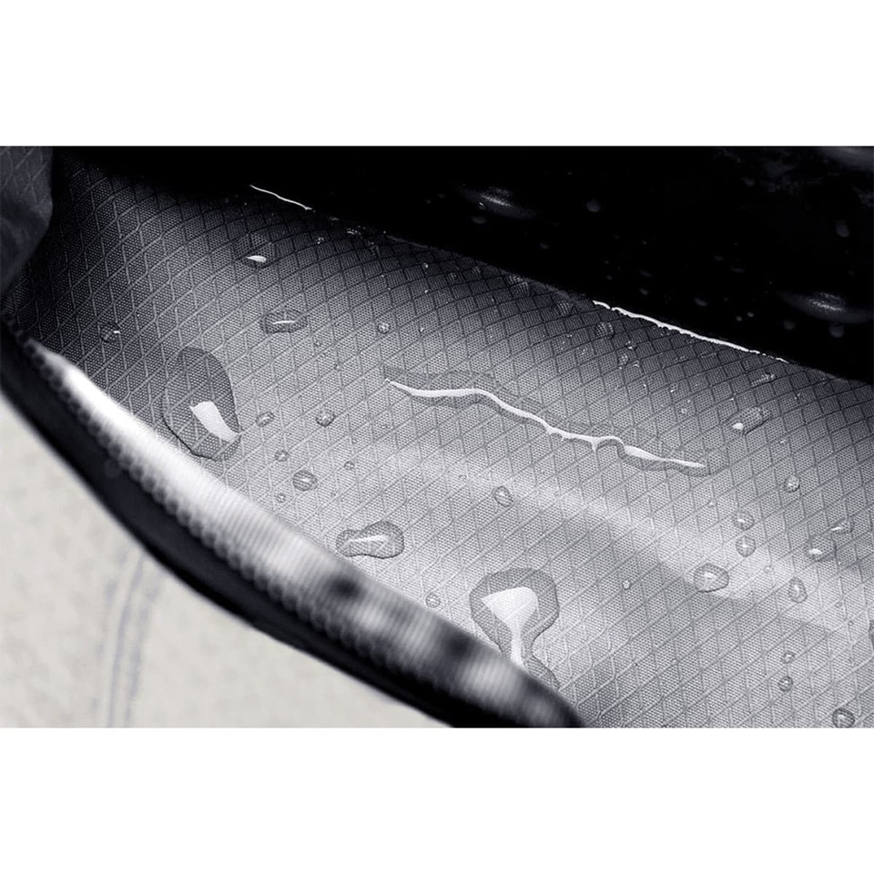 A cooler bag featuring a textured interior with water droplets, showcasing its waterproof design. It has a logo.